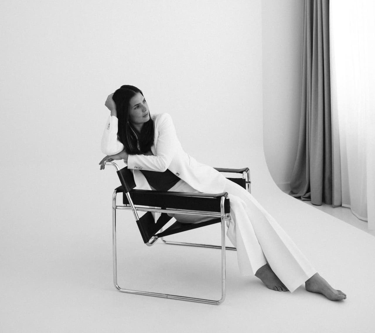 Anna Harmat seated in a minimalist interior